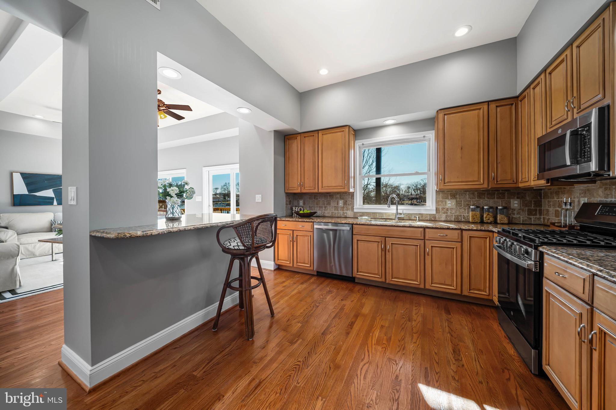 8101 Shore Road Baltimore, MD 21222 - Photo 11 of 35 a kitchen with a sink cabinets a counter top space and stainless steel appliances