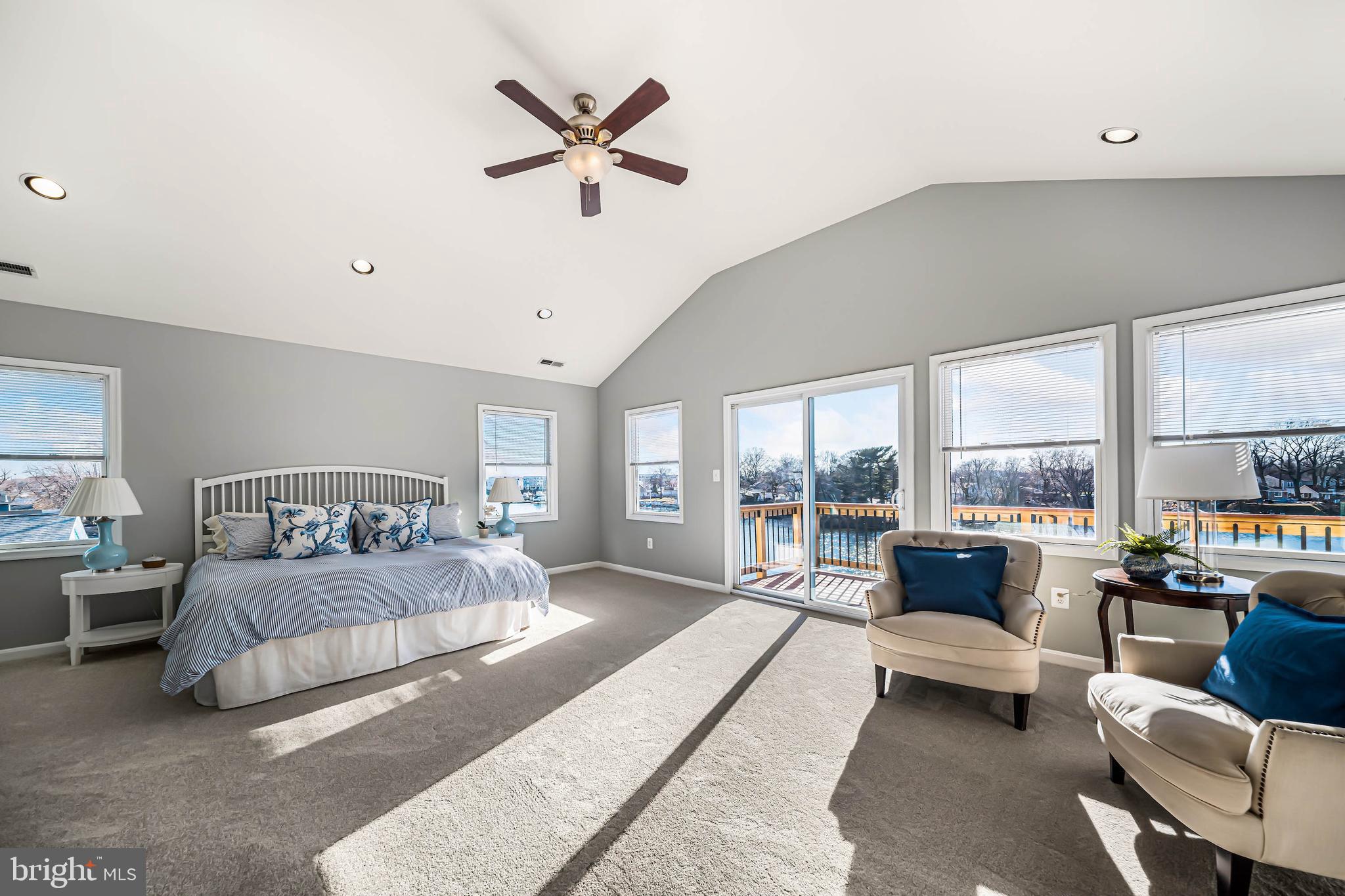 8101 Shore Road Baltimore, MD 21222 - Photo 12 of 35 a bedroom with a large bed couch and a large window