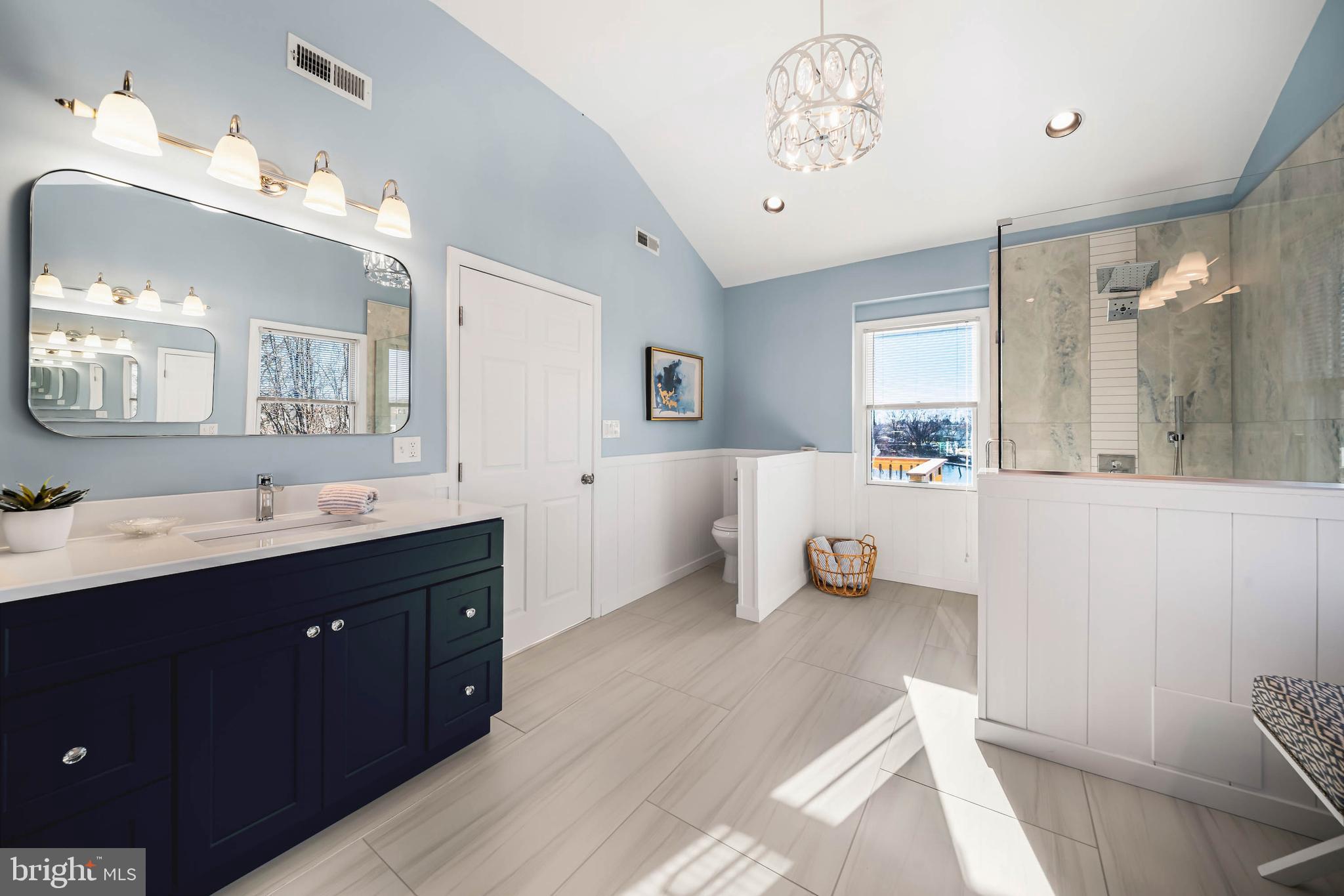 8101 Shore Road Baltimore, MD 21222 - Photo 15 of 35 a spacious bathroom with a double vanity sink and a mirror