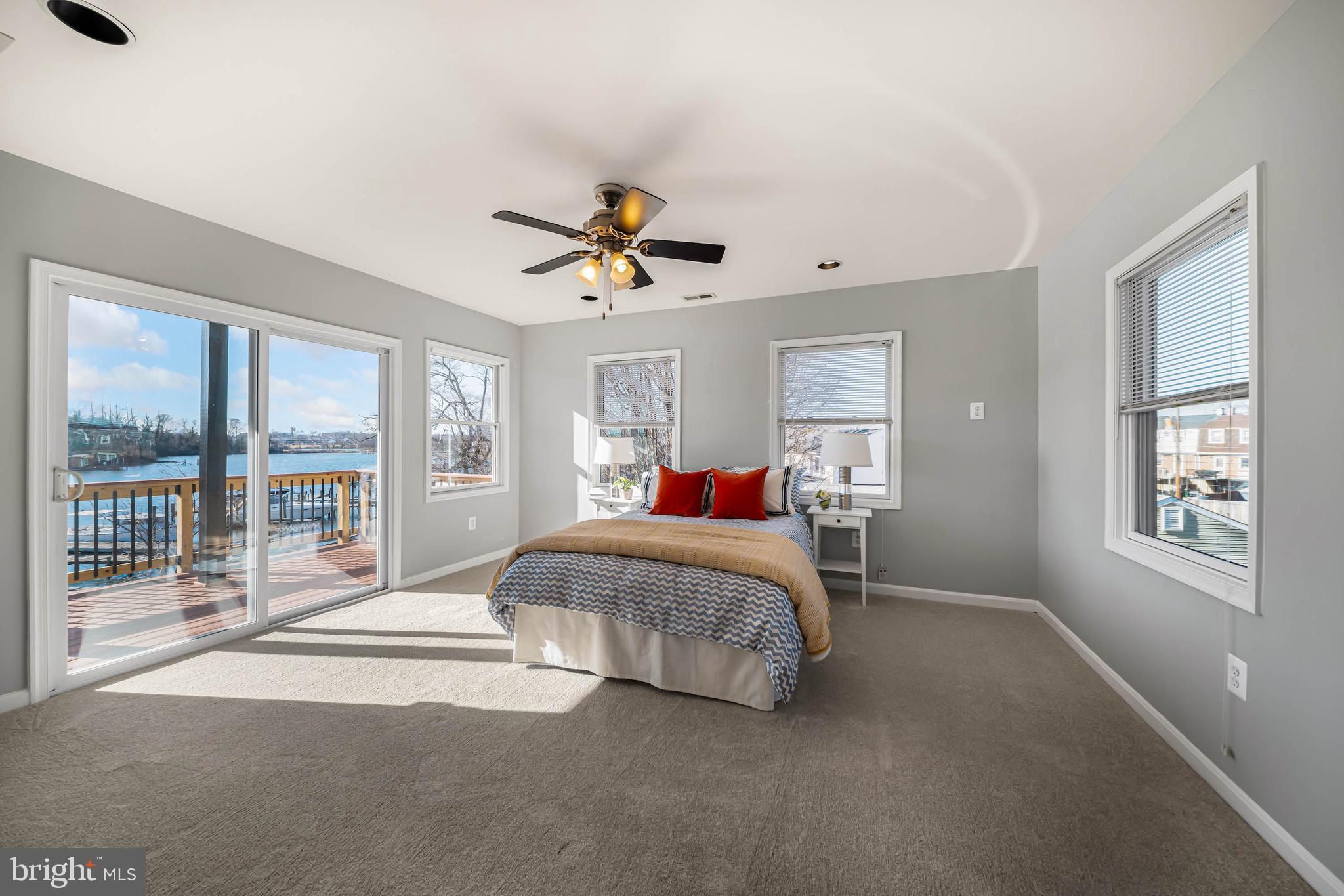 8101 Shore Road Baltimore, MD 21222 - Photo 18 of 35 a bedroom with a large bed and a chandelier