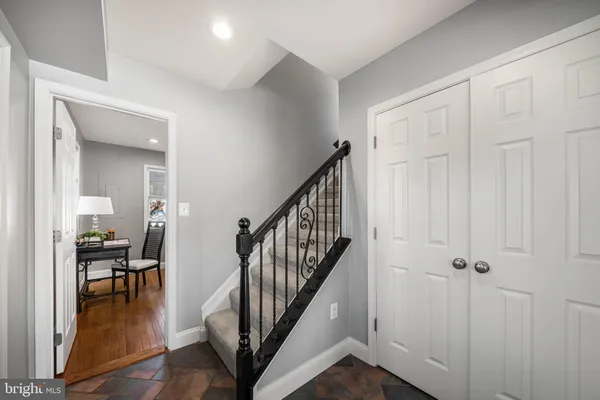a view of a hallway with dining room and stairs