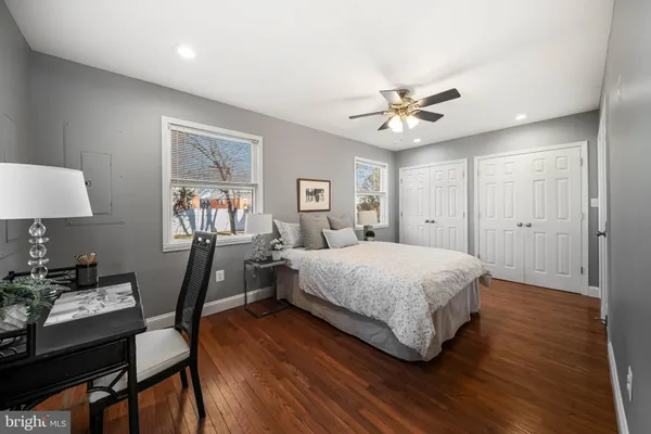 a spacious bedroom with a bed and a table in it