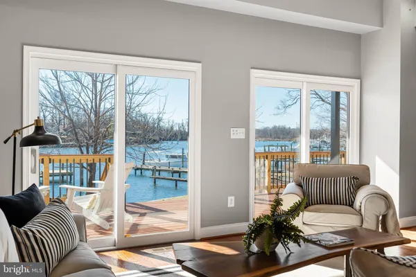 a living room with furniture and a floor to ceiling window