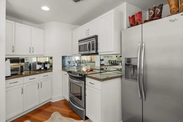 a kitchen with stainless steel appliances granite countertop a refrigerator sink and stove