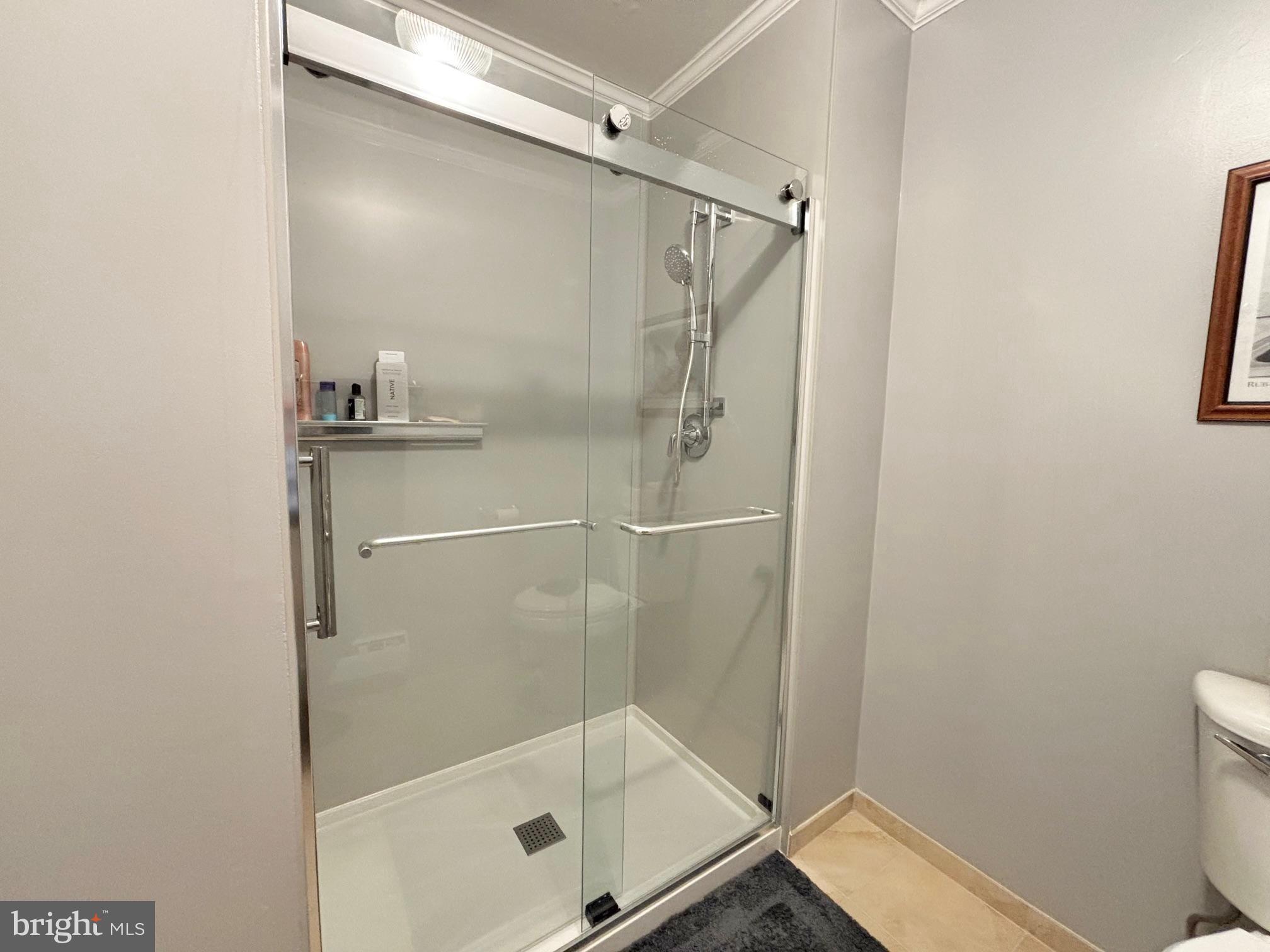 15111 Glade Drive, Unit 123D Silver Spring, MD 20906 - Photo 13 of 23 a bathroom with a glass shower door