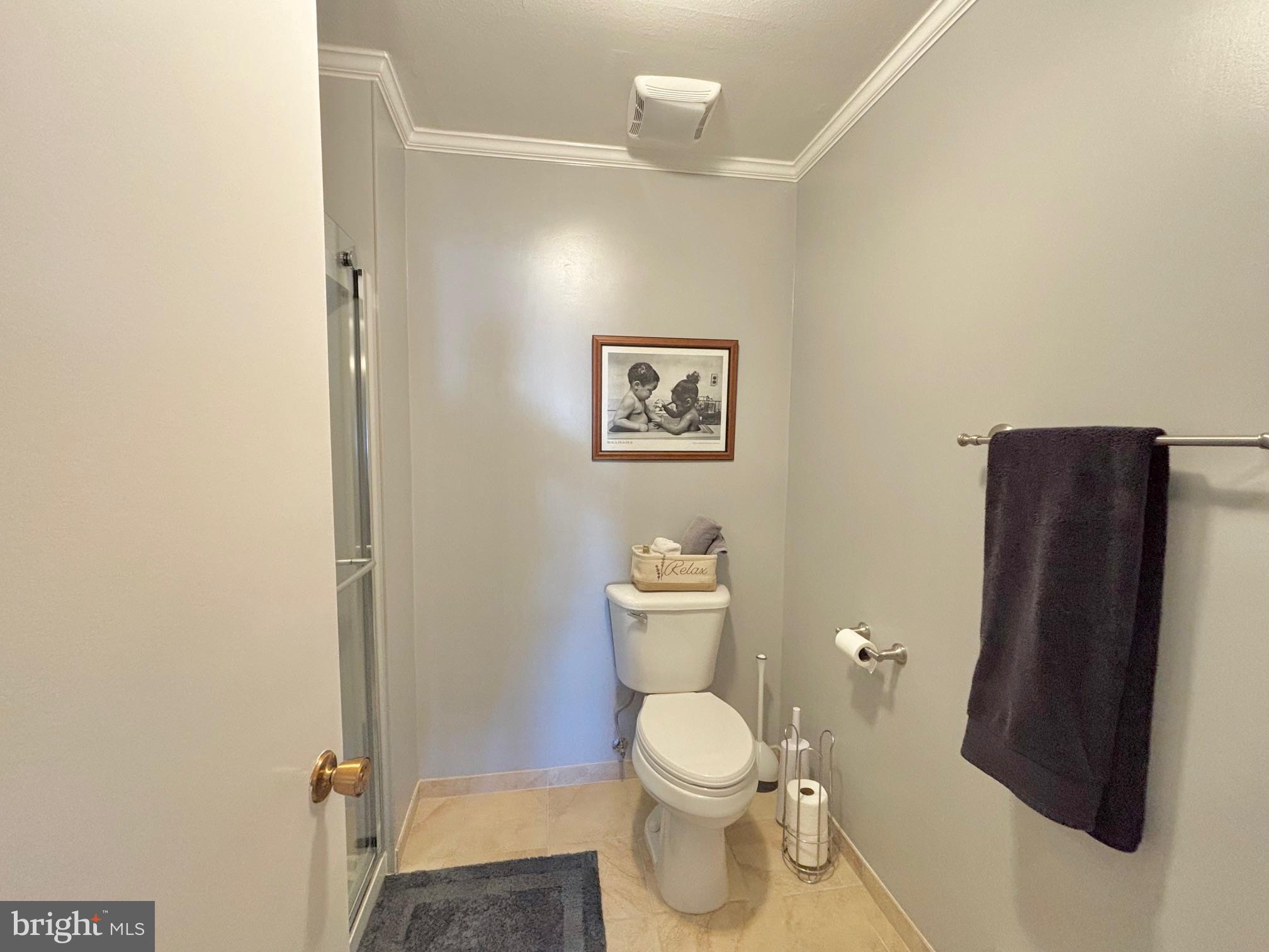 15111 Glade Drive, Unit 123D Silver Spring, MD 20906 - Photo 14 of 23 a white toilet sitting next to a small bathroom