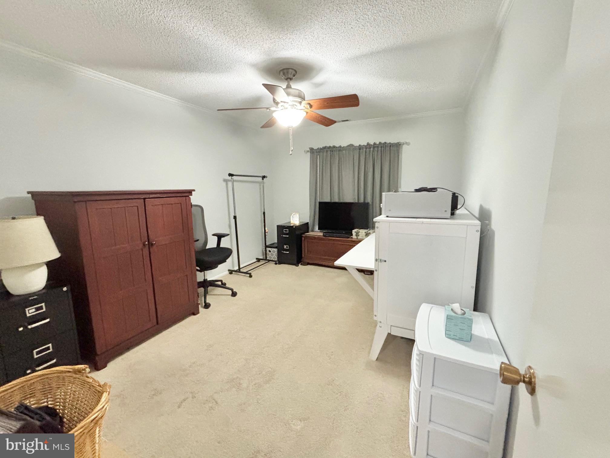 15111 Glade Drive, Unit 123D Silver Spring, MD 20906 - Photo 16 of 23 a bed room with a bed and a television