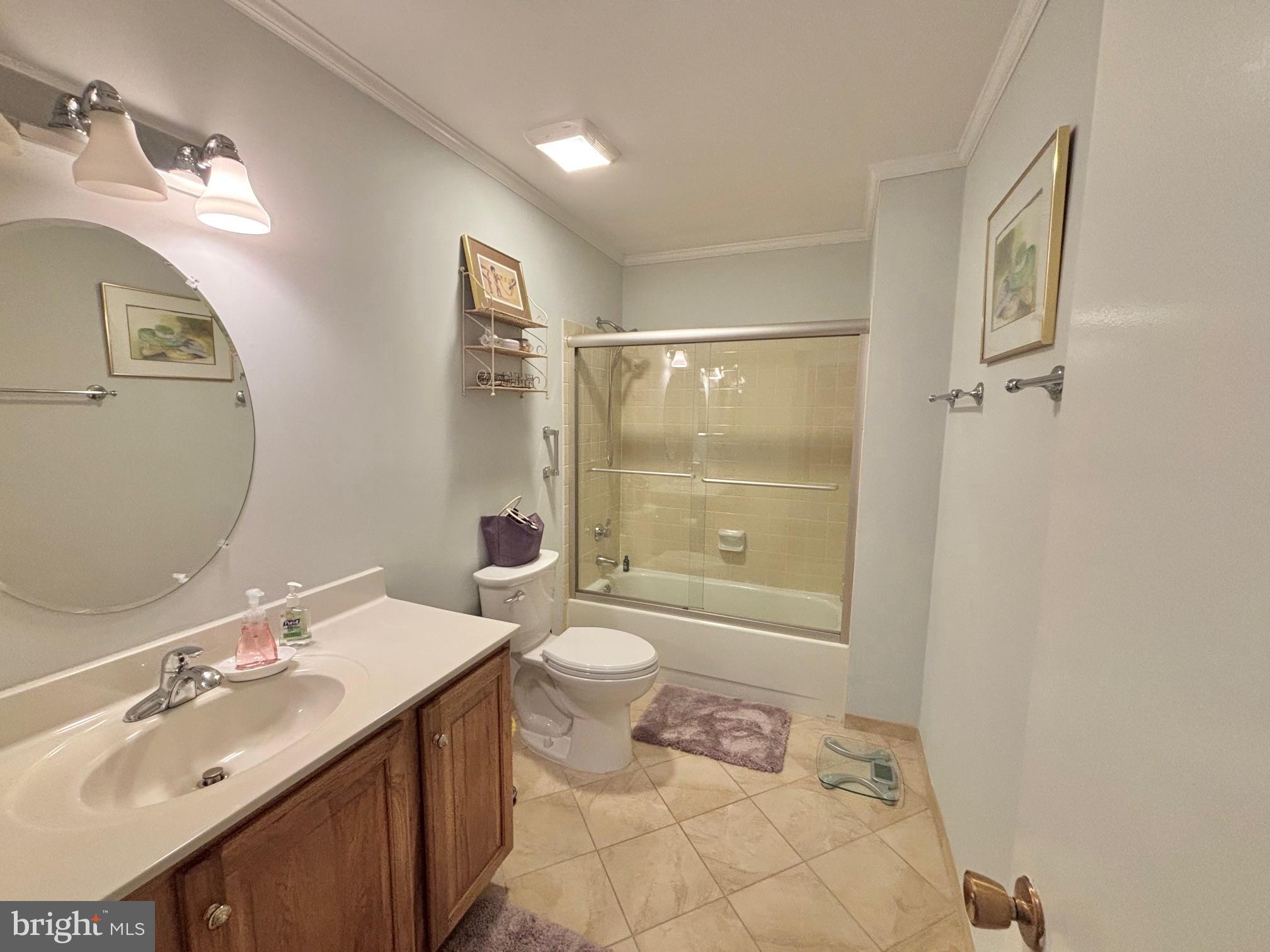 15111 Glade Drive, Unit 123D Silver Spring, MD 20906 - Photo 17 of 23 a bathroom with a double vanity sink toilet mirror and shower