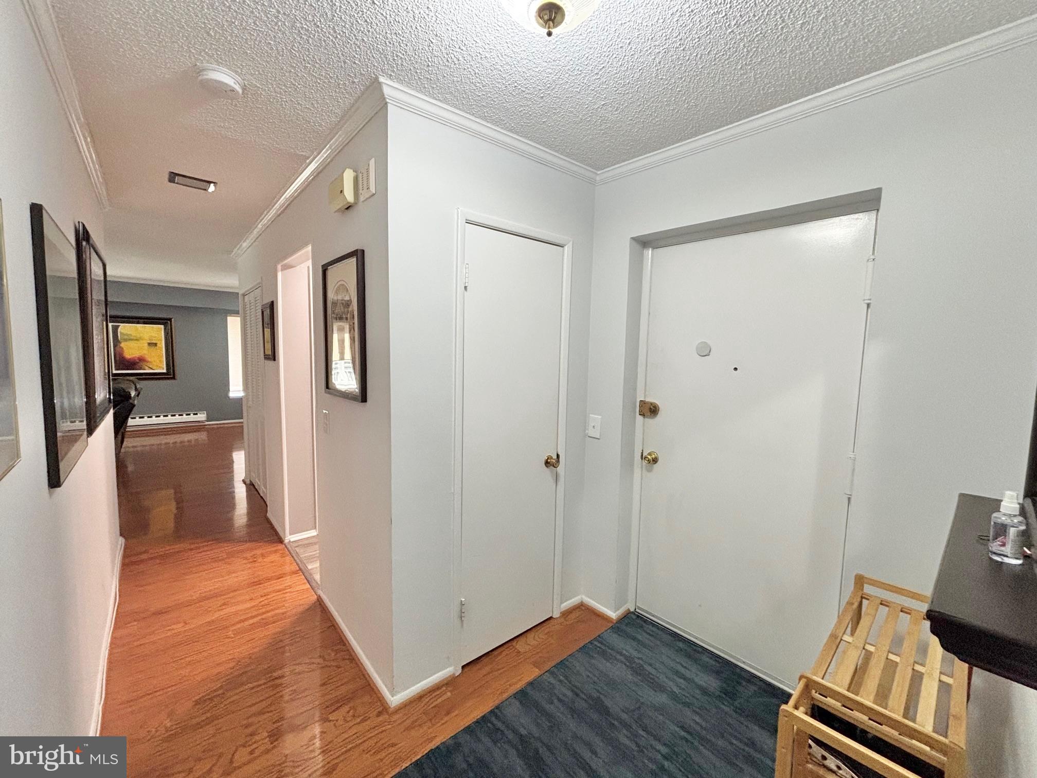 15111 Glade Drive, Unit 123D Silver Spring, MD 20906 - Photo 2 of 23 a view of a hallway with wooden floor and closet