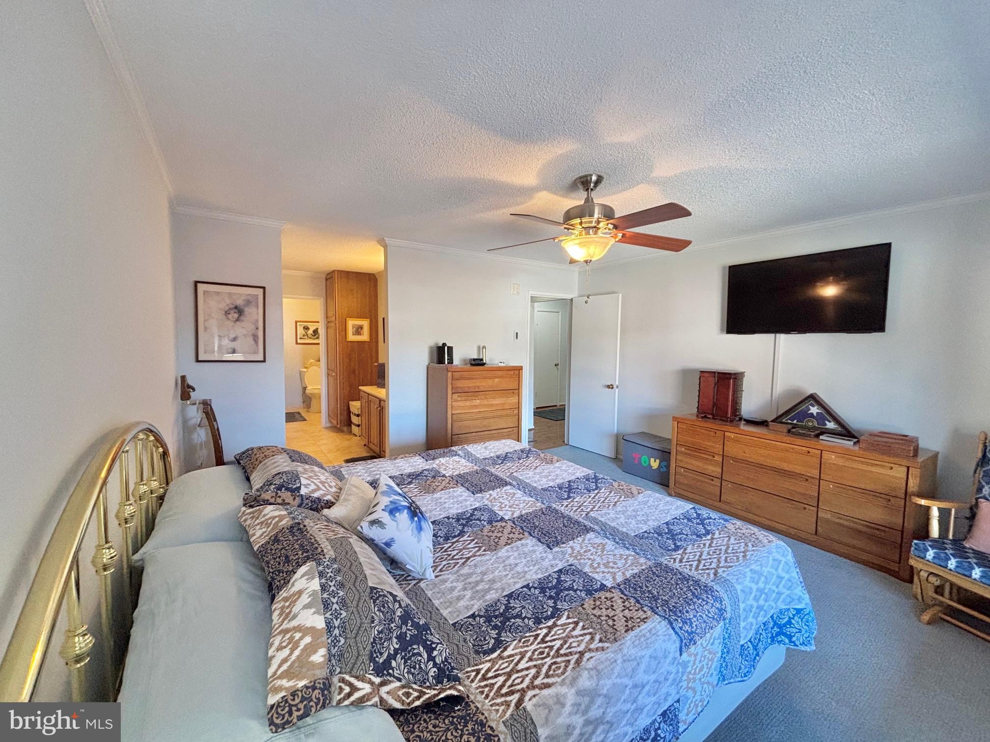 15111 Glade Drive, Unit 123D Silver Spring, MD 20906 - Photo 10 of 23 a bedroom with a bed and a flat screen tv