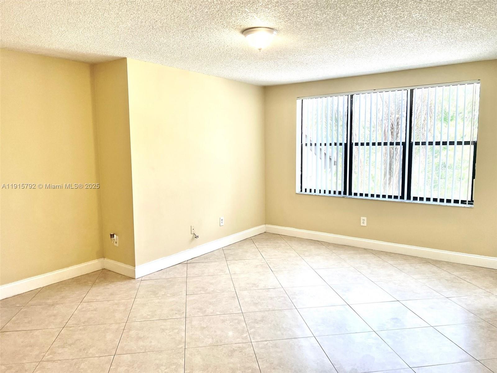 4561 West McNab Road, Unit 16 Pompano Beach, FL 33069 - Photo 1 of 14 a view of an empty room with a window