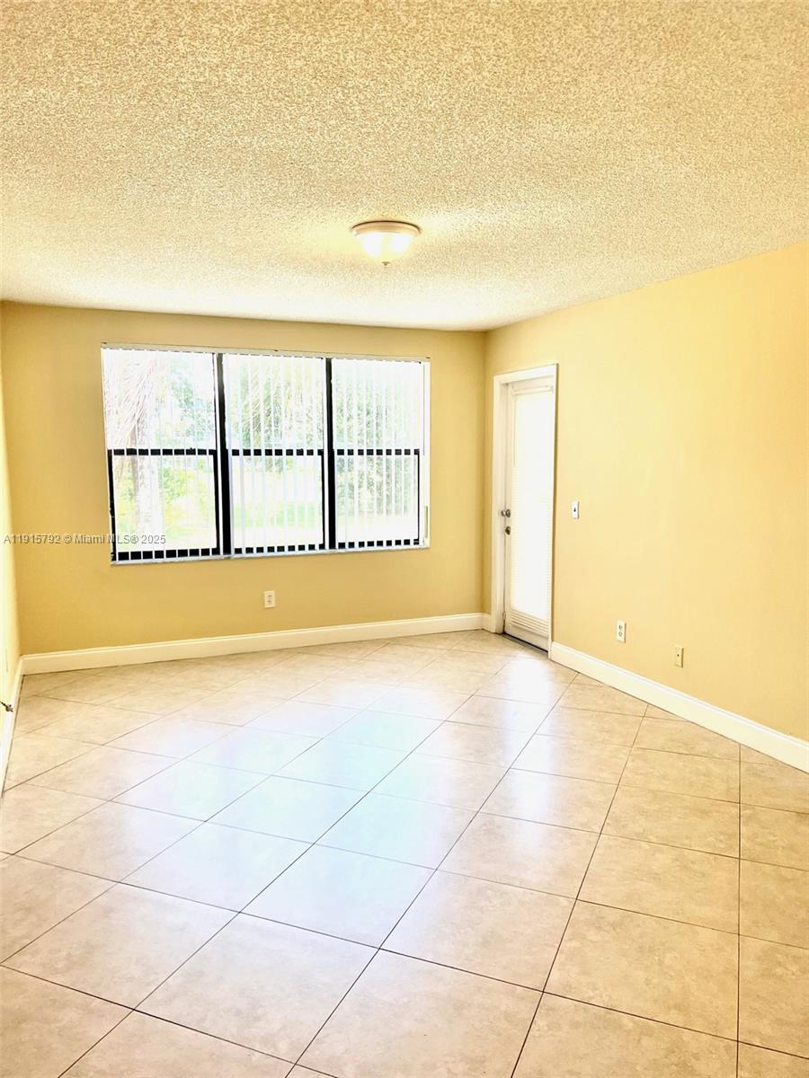 4561 West McNab Road, Unit 16 Pompano Beach, FL 33069 - Photo 2 of 14 a view of an empty room with a window