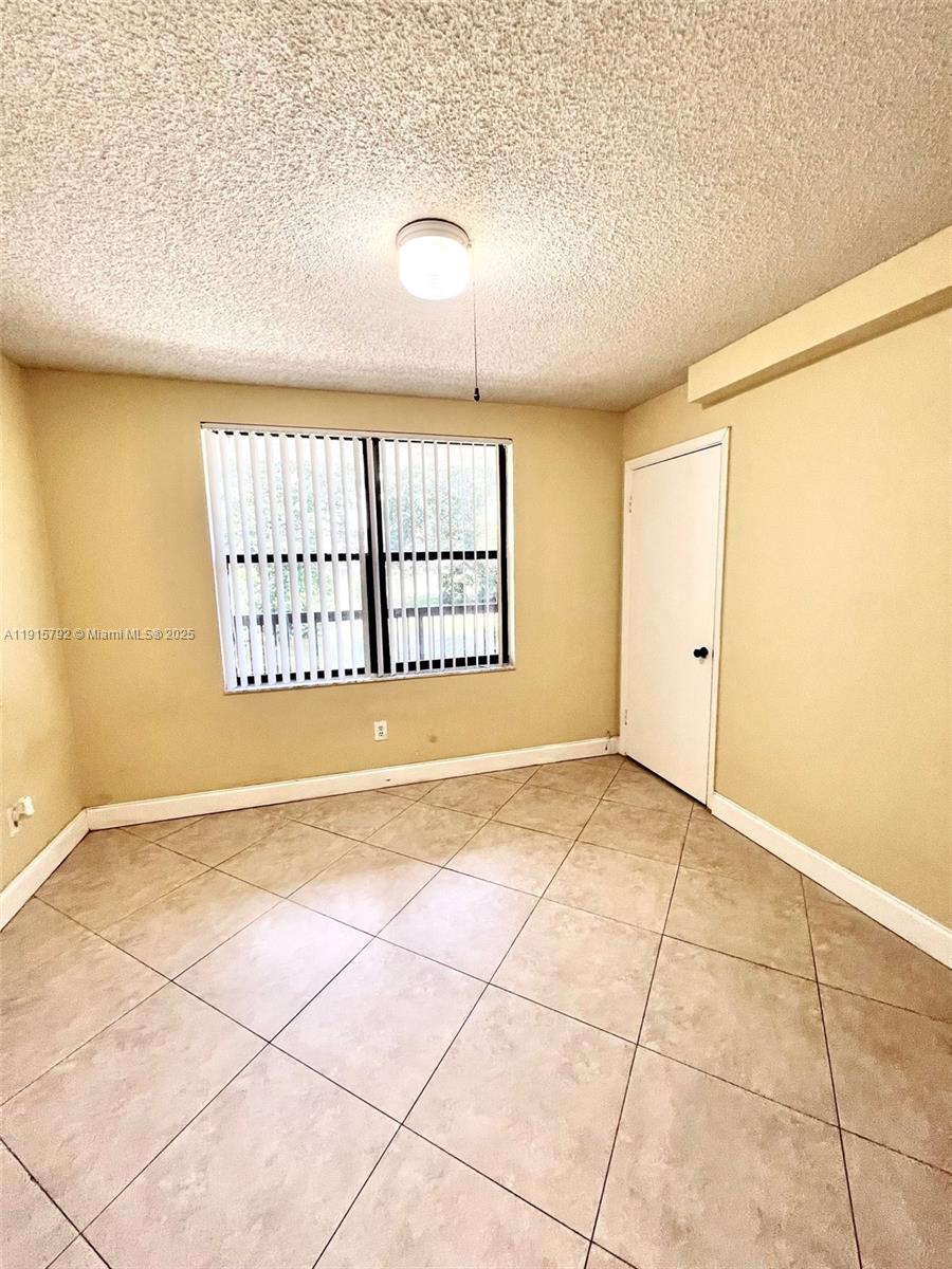 4561 West McNab Road, Unit 16 Pompano Beach, FL 33069 - Photo 8 of 14 a view of an empty room with a window