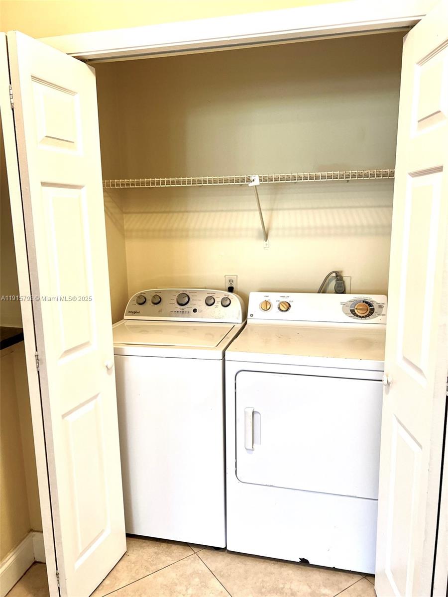 4561 West McNab Road, Unit 16 Pompano Beach, FL 33069 - Photo 9 of 14 a utility room with dryer and washer