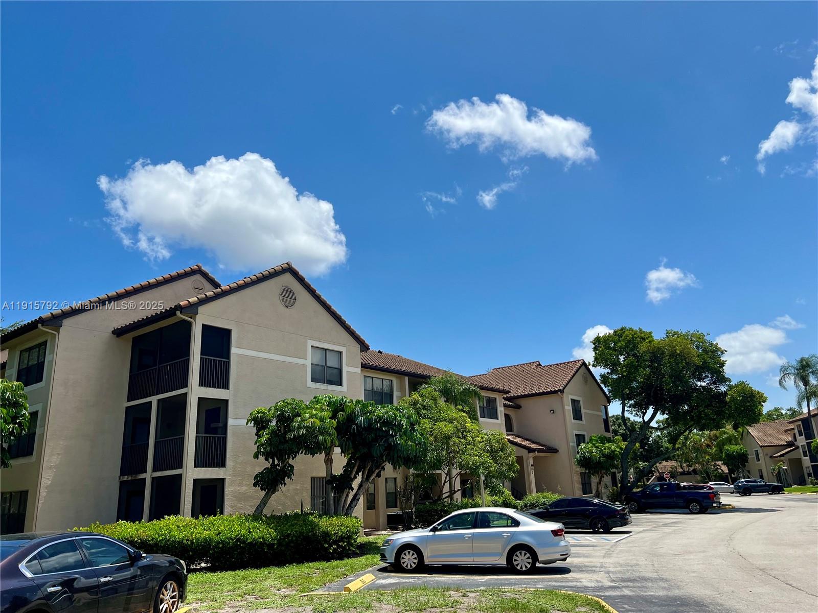 4561 West McNab Road, Unit 16 Pompano Beach, FL 33069 - Photo 10 of 14 a front view of a house with a yard