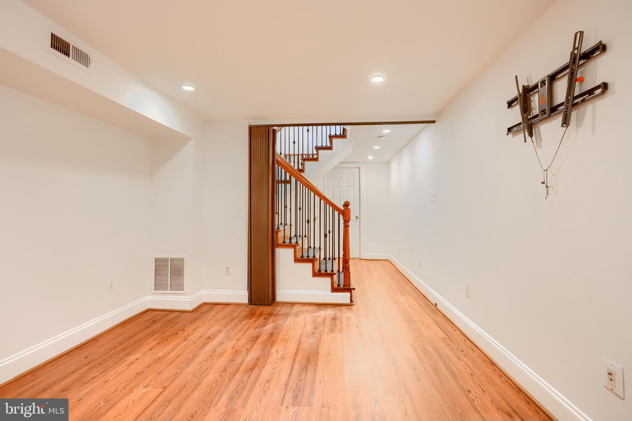 1520 Byrd Street Baltimore, MD 21230 - Photo 19 of 36 a view of a hallway with wooden floor and stairs