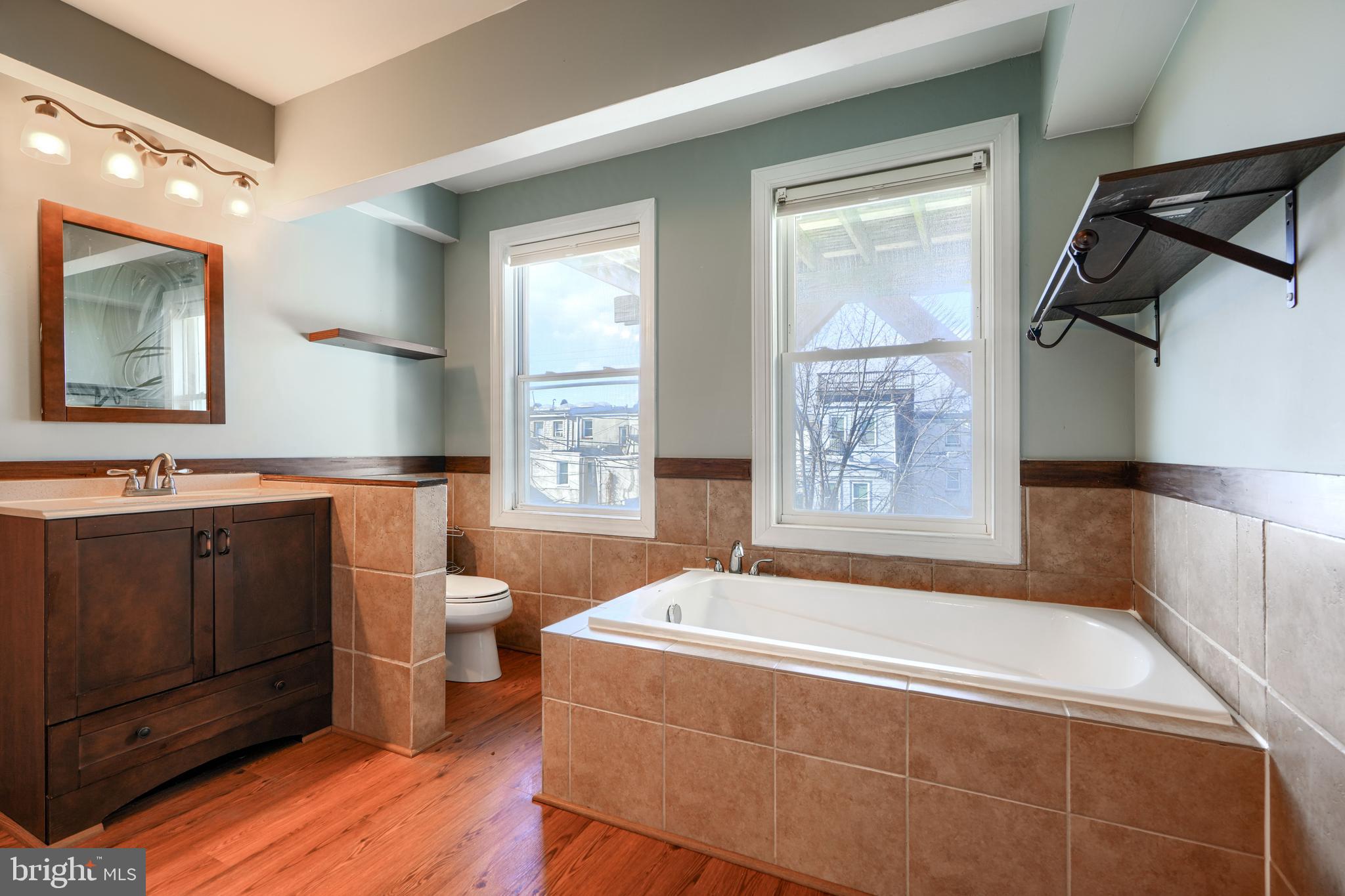 1520 Byrd Street Baltimore, MD 21230 - Photo 25 of 36 a spacious bathroom with a tub sink and mirror