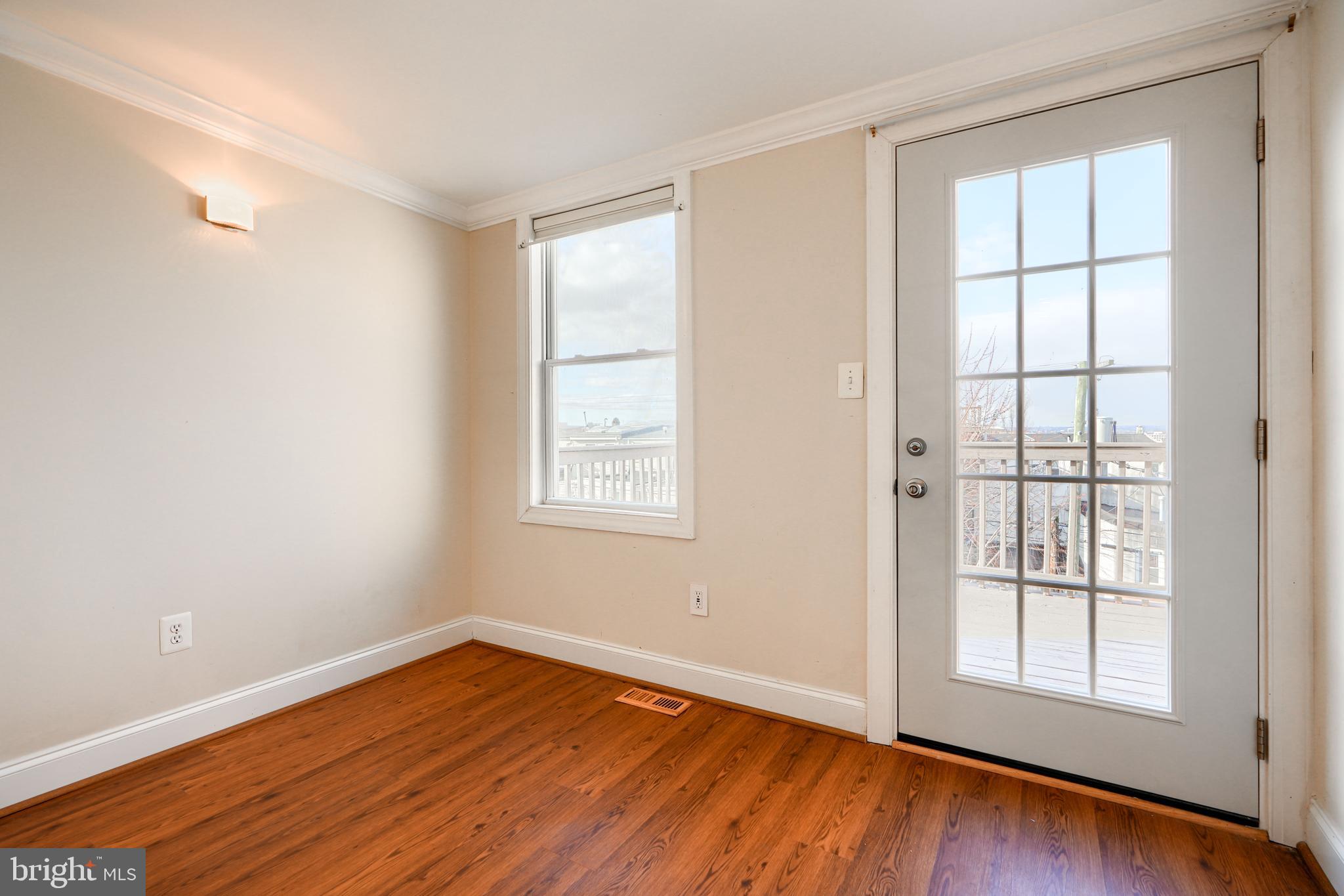 1520 Byrd Street Baltimore, MD 21230 - Photo 32 of 36 an empty room with wooden floor and windows