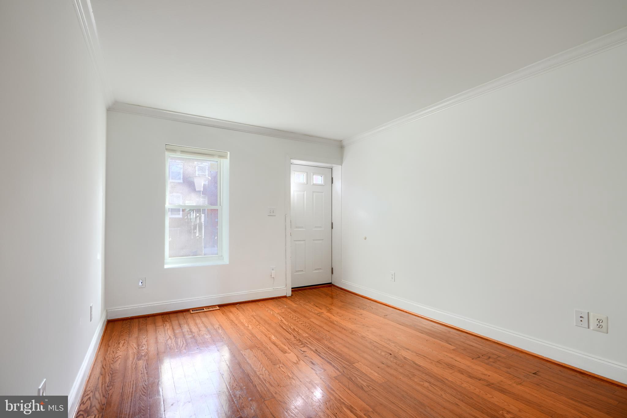 1520 Byrd Street Baltimore, MD 21230 - Photo 5 of 36 an empty room with wooden floor and windows