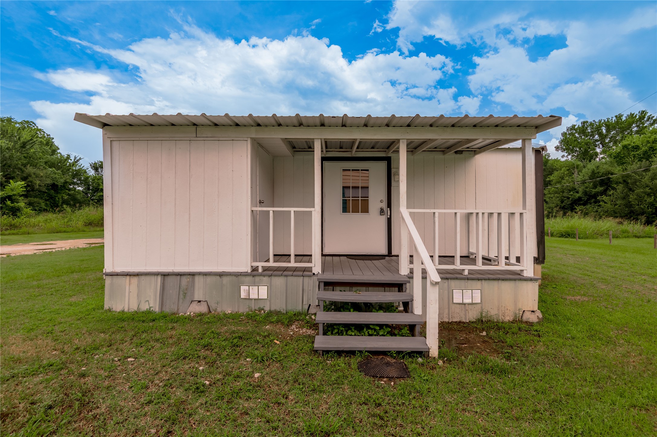 128 Johnnie Street Trinity, TX 75862 - Photo 1 of 19 front view of a house with a garden