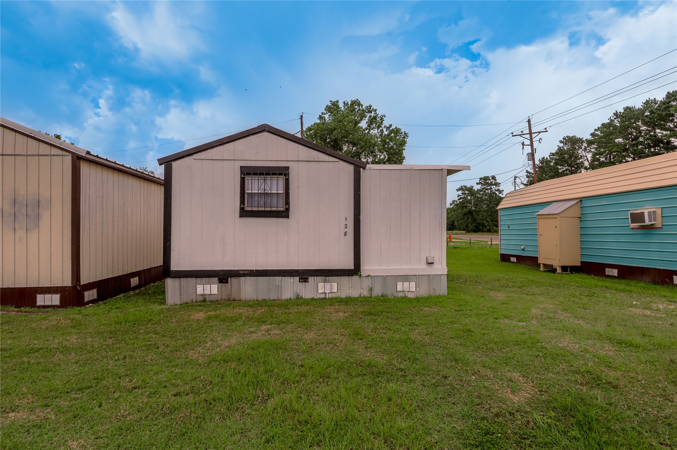 128 Johnnie Street Trinity, TX 75862 - Photo 18 of 19 a house with garden in front of it