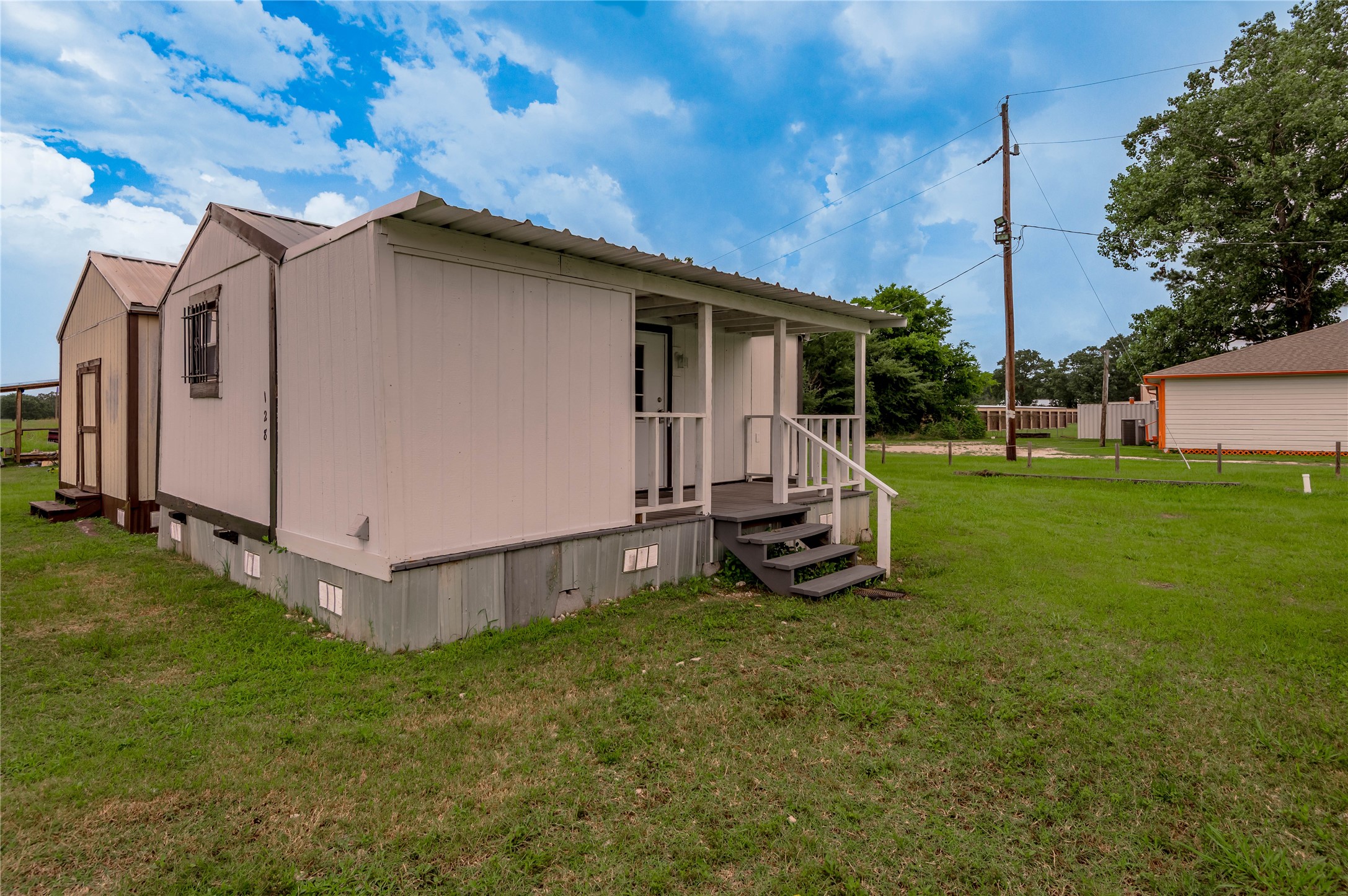 128 Johnnie Street Trinity, TX 75862 - Photo 19 of 19 a view of a backyard with a garden and parked area