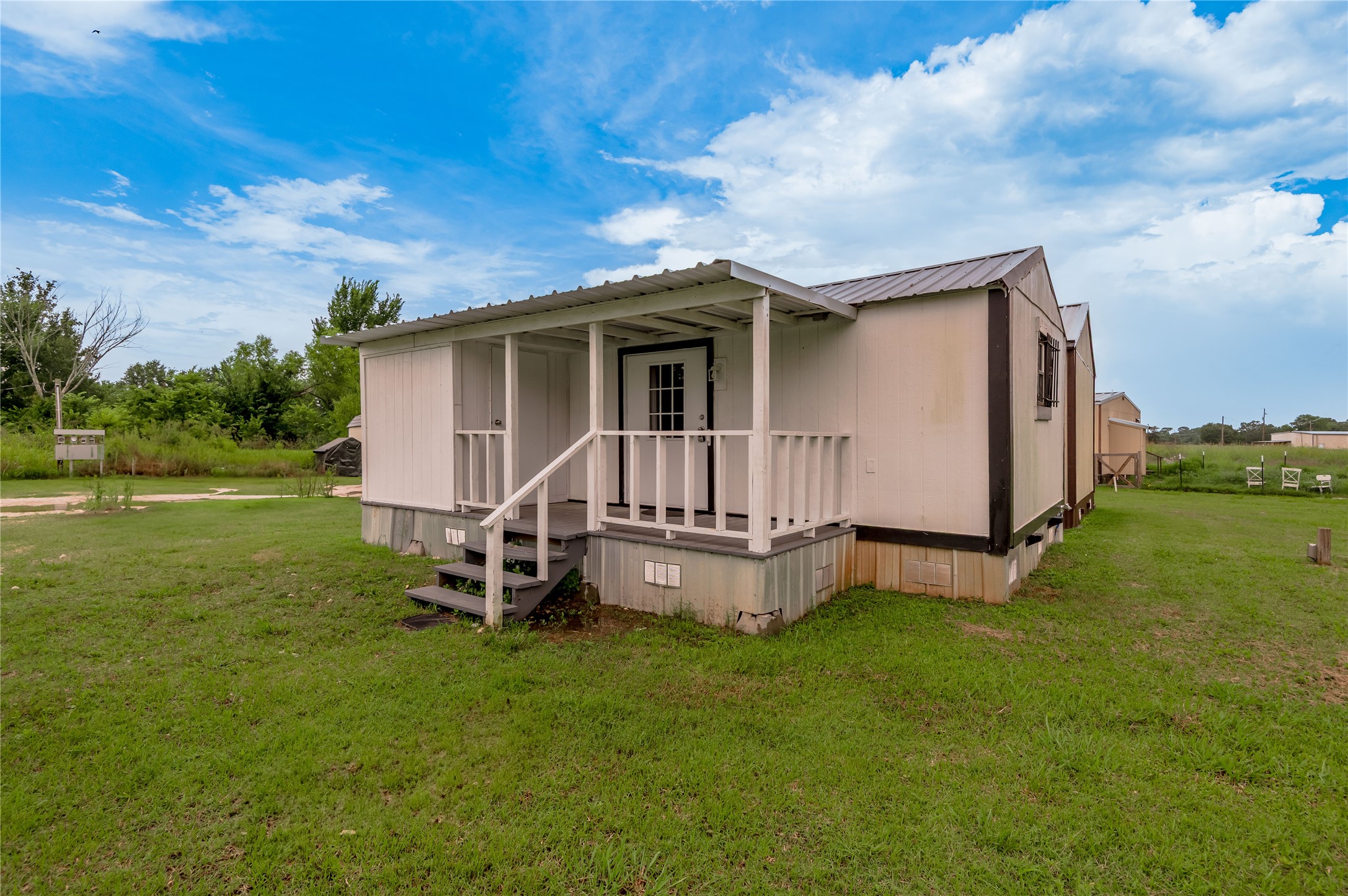 128 Johnnie Street Trinity, TX 75862 - Photo 2 of 19 a view of a house with a yard