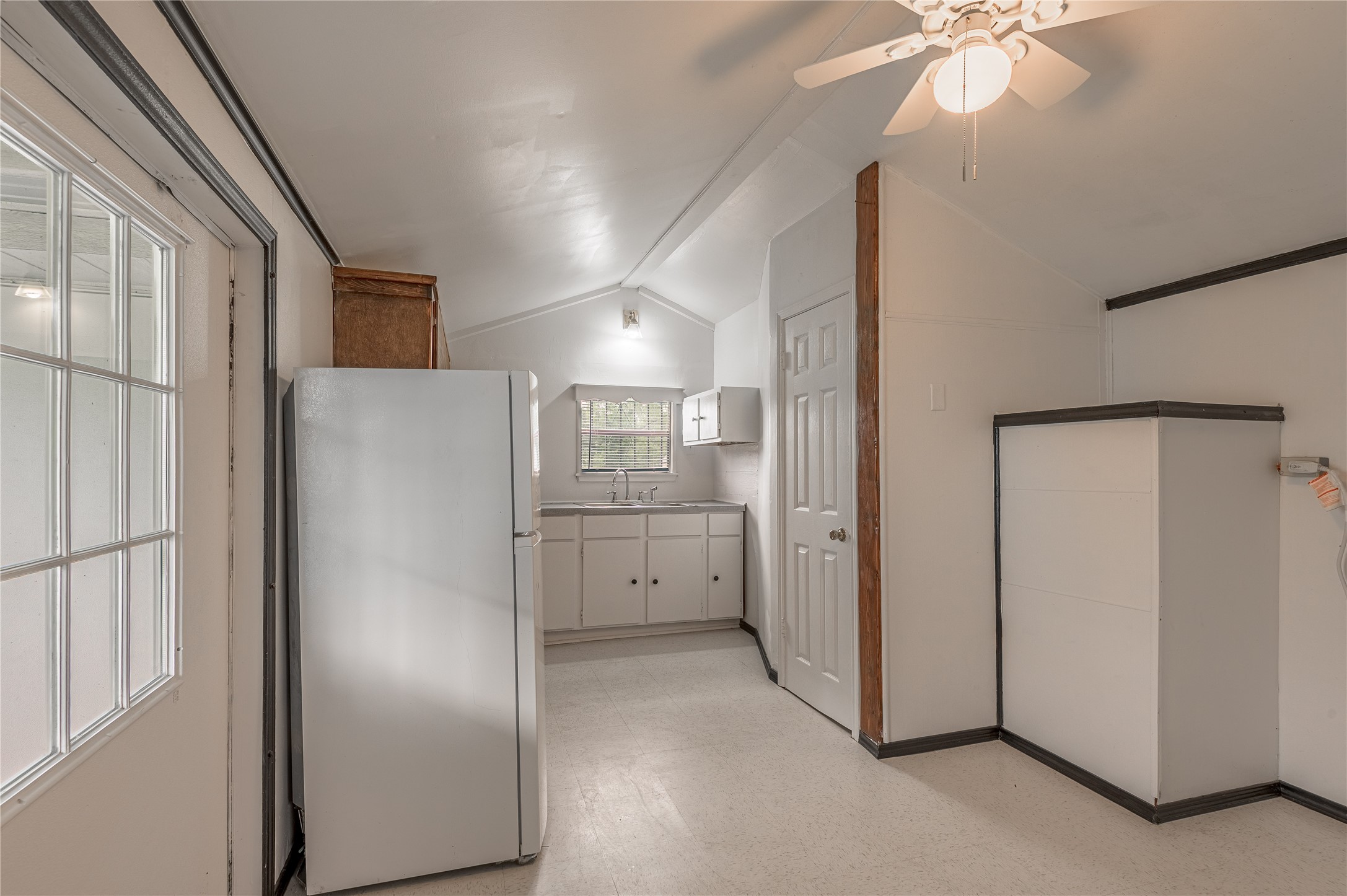 128 Johnnie Street Trinity, TX 75862 - Photo 4 of 19 a view of a kitchen with refrigerator and a chandelier