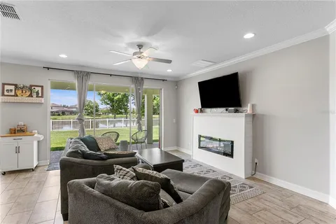 a living room with lots of furniture and a large window