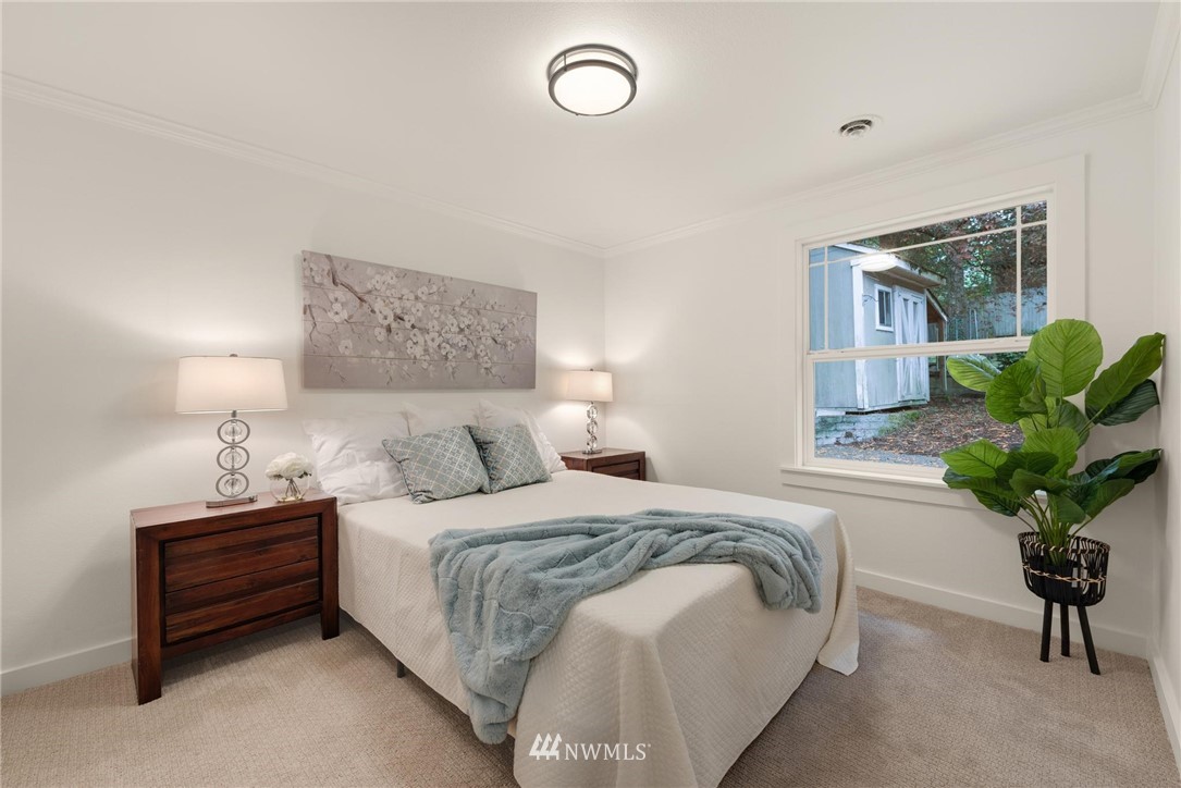 11519 32nd Avenue Northeast Seattle, WA 98125 - Photo 11 of 17 a bedroom that has a bed and a potted plant