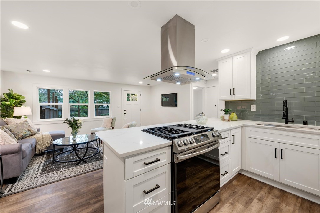 11519 32nd Avenue Northeast Seattle, WA 98125 - Photo 9 of 17 a kitchen with a stove a sink and a refrigerator