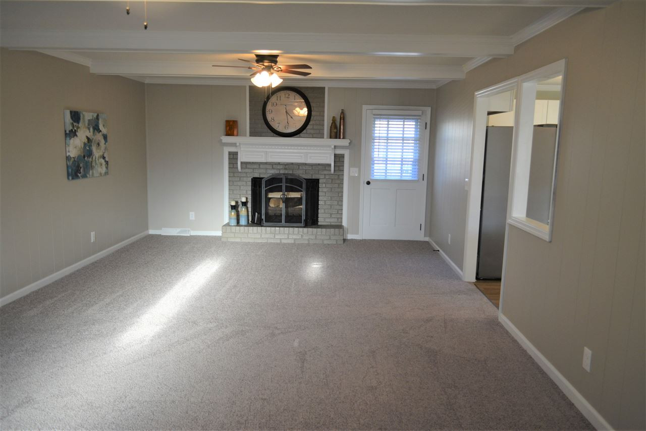 7249 Rock Service Station Road Raleigh, NC 27603 - Photo 9 of 25 Bonus Wood beams*Huge spacious Room for family & friends*new paint, new plush carpet*wood burning masonry fireplace! Huge Great Room for Family & Friends