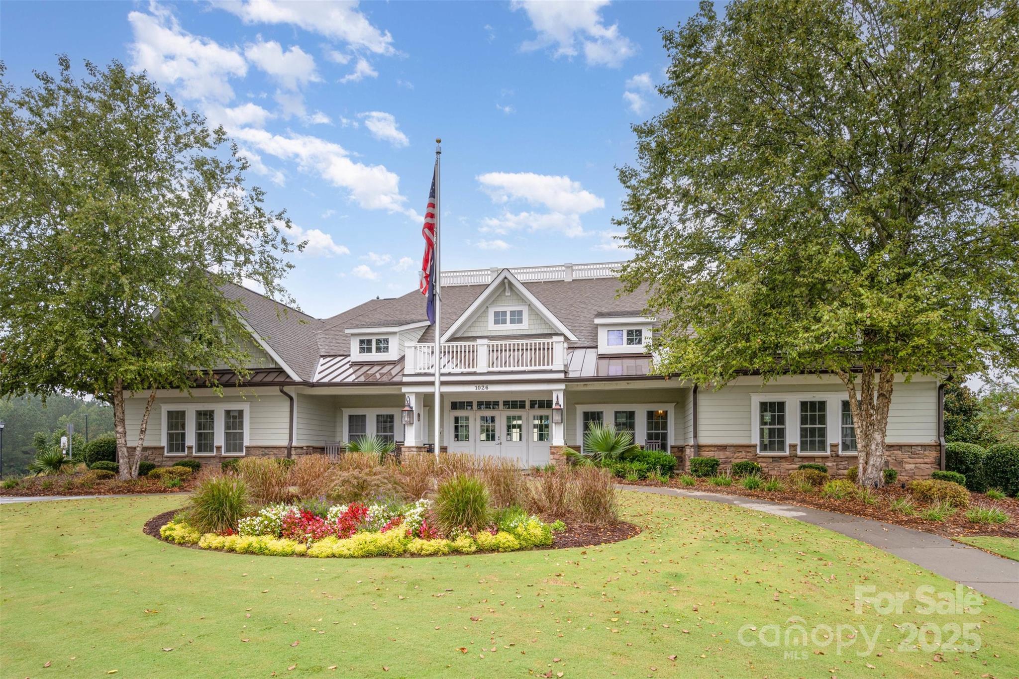 6883 Spring Peeper Lane Lancaster, SC 29720 - Photo 31 of 42 a front view of a house with a yard table and chairs