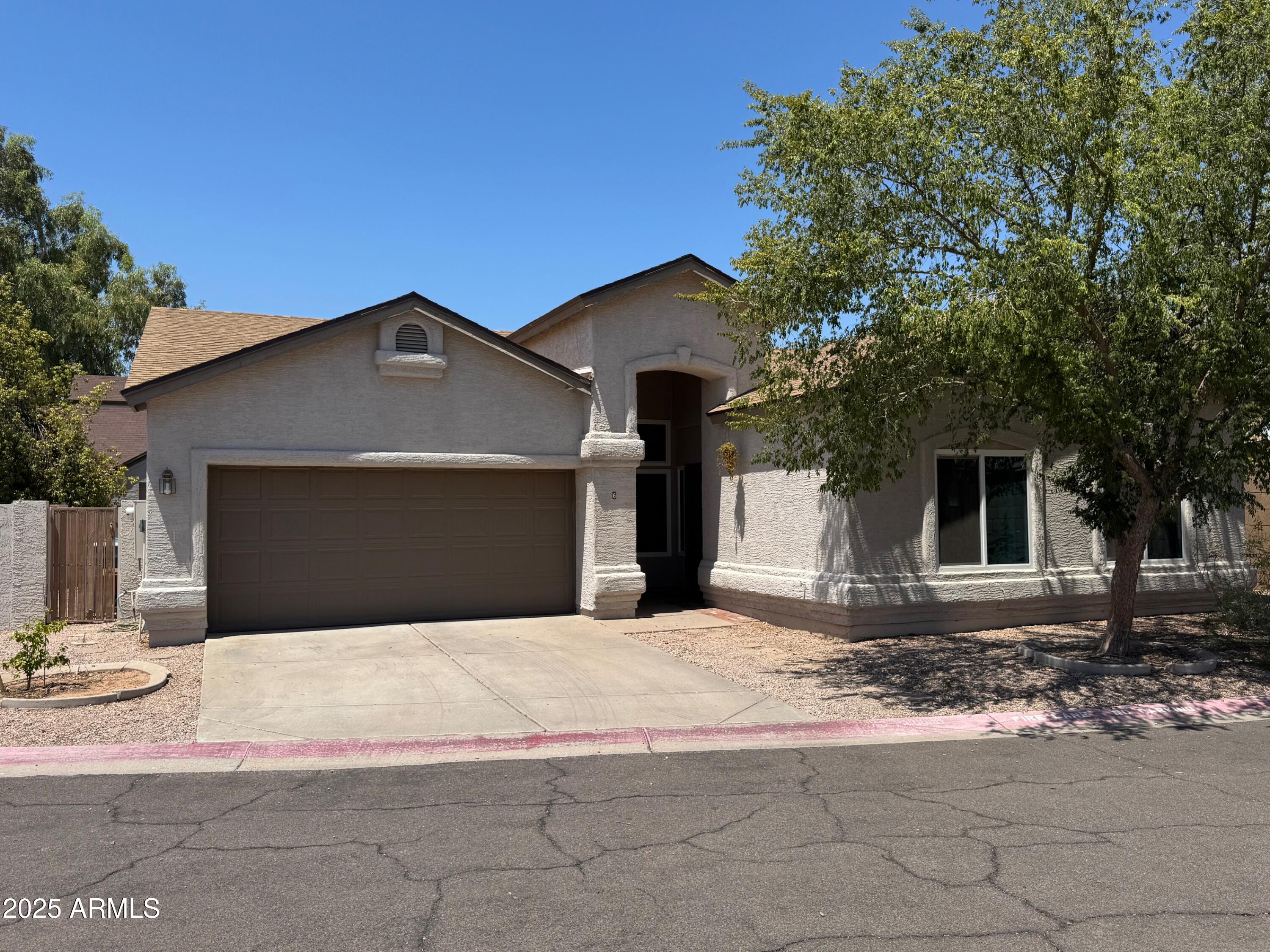 1822 South 39th Street, Unit 6 Mesa, AZ 85206 - Photo 1 of 18 a front view of a house with a yard and garage