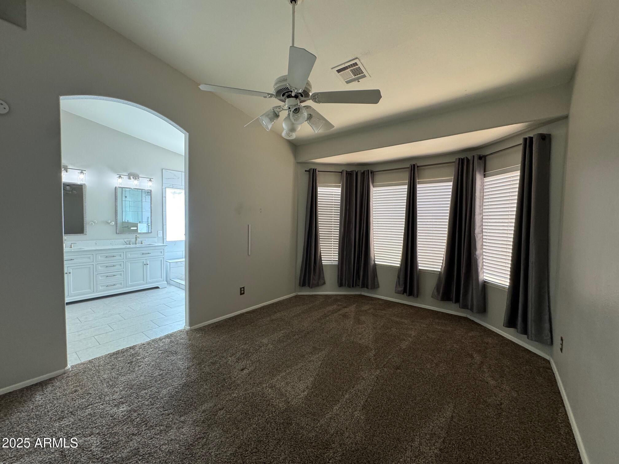 1822 South 39th Street, Unit 6 Mesa, AZ 85206 - Photo 13 of 18 a view of a hallway with a chandelier fan and windows