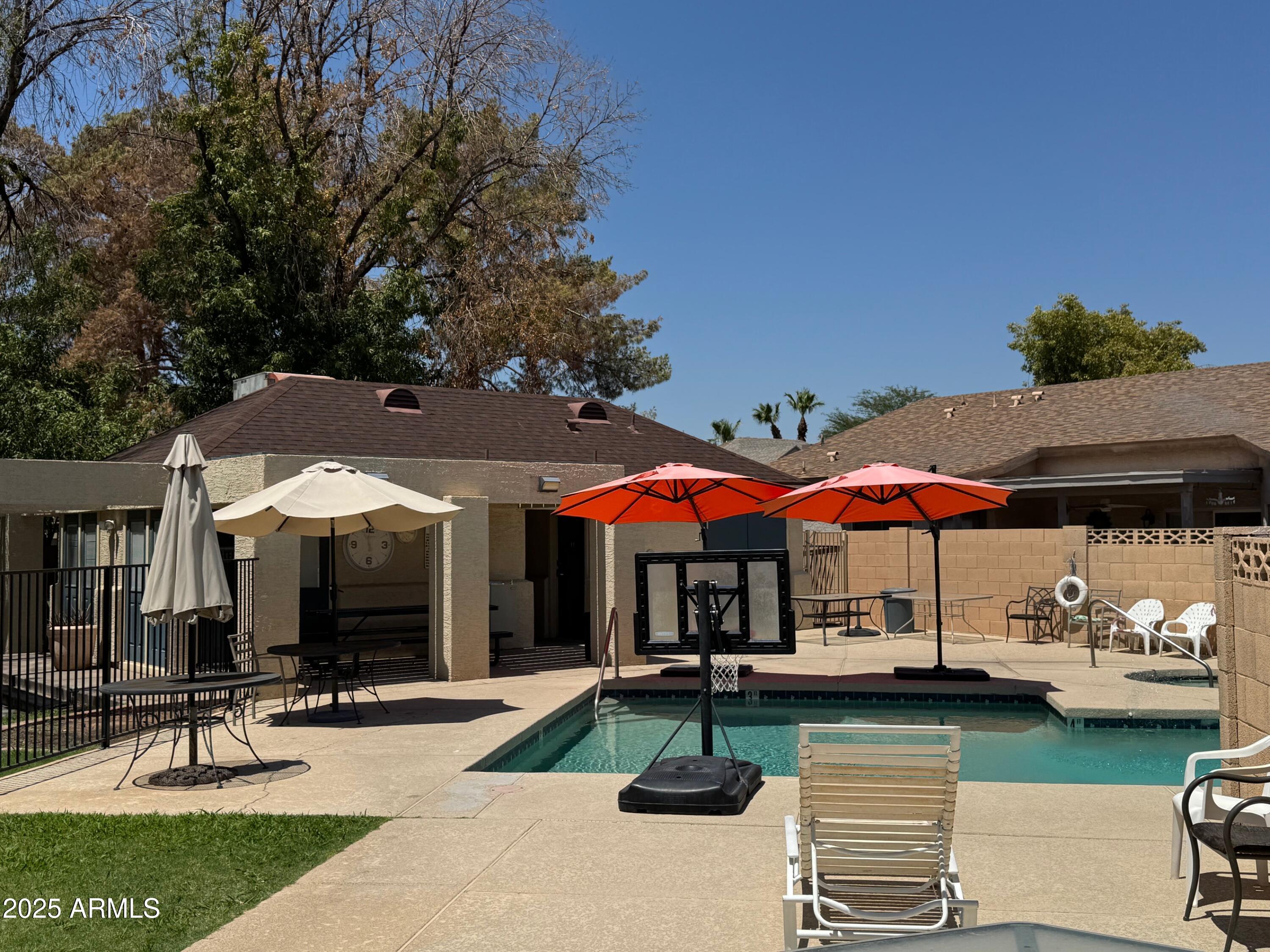 1822 South 39th Street, Unit 6 Mesa, AZ 85206 - Photo 2 of 18 a view of a patio with chairs and table under an umbrella