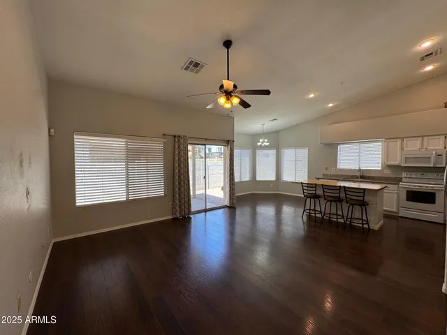 a view of a livingroom with furniture wooden floor and chandelier