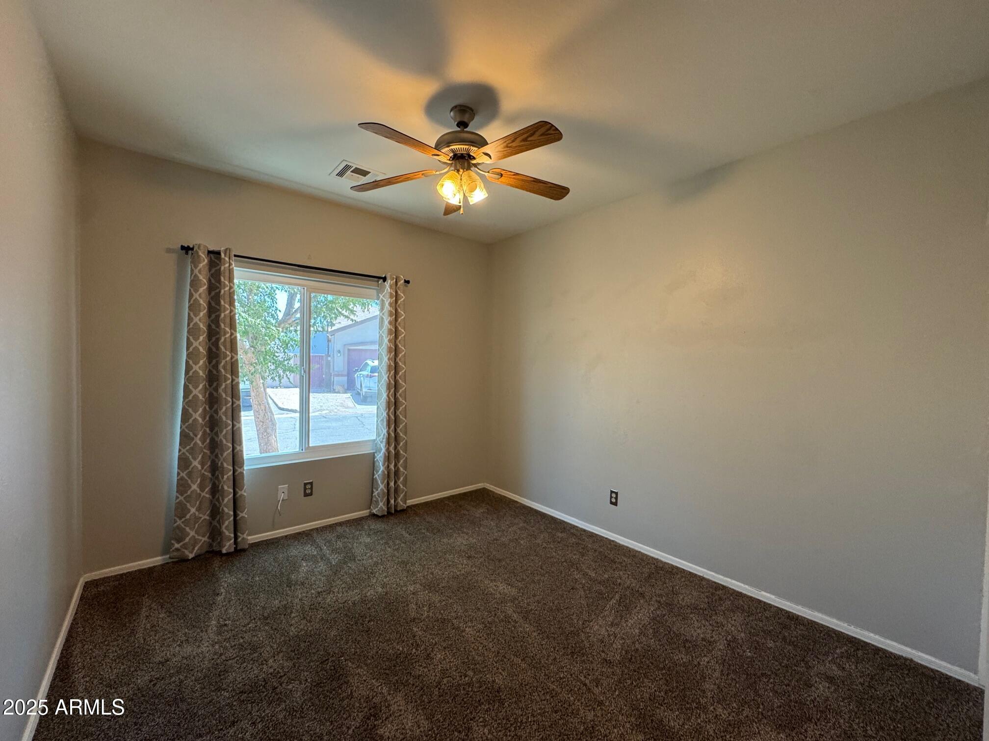 1822 South 39th Street, Unit 6 Mesa, AZ 85206 - Photo 10 of 18 an empty room with windows and fan
