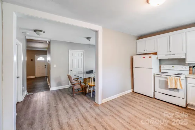 a view of kitchen with wooden floor and electronic appliances