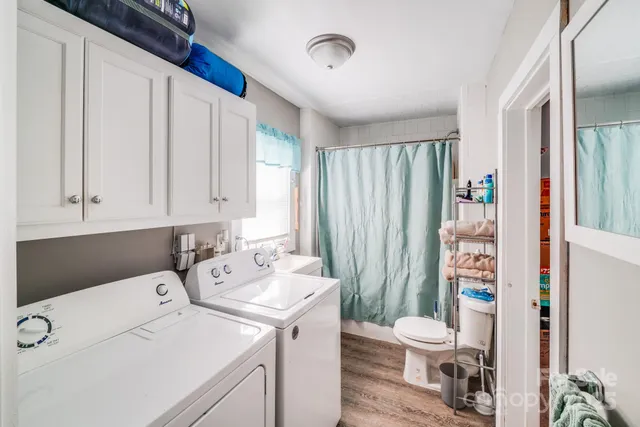 a bathroom with a sink a toilet and shower curtain