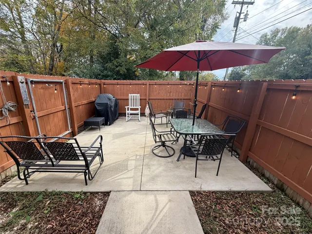 a patio with a patio table and chairs