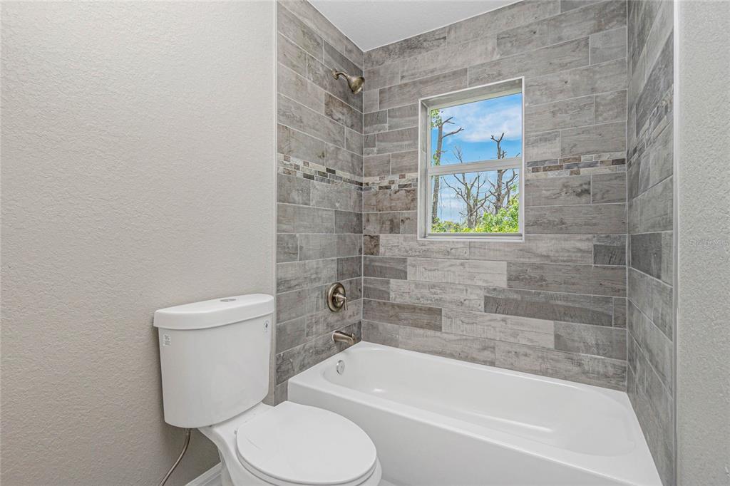 12 Current Lane Placida, FL 33946 - Photo 5 of 16 a bath room with a toilet and a bath tub