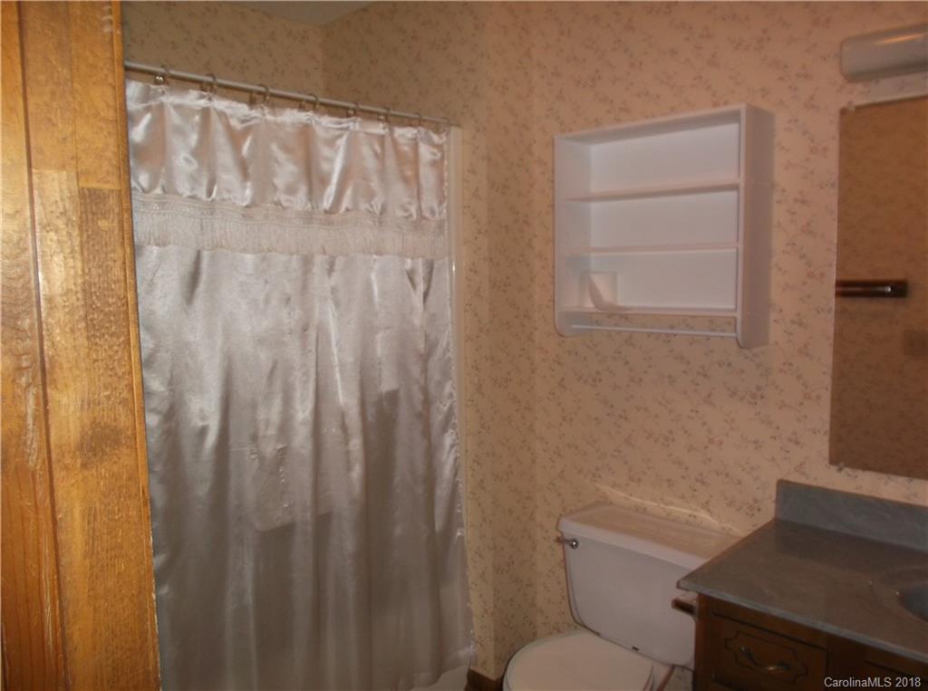 1835 Rainey Road Salisbury, NC 28146 - Photo 13 of 17 a bathroom with a toilet and a shower curtain