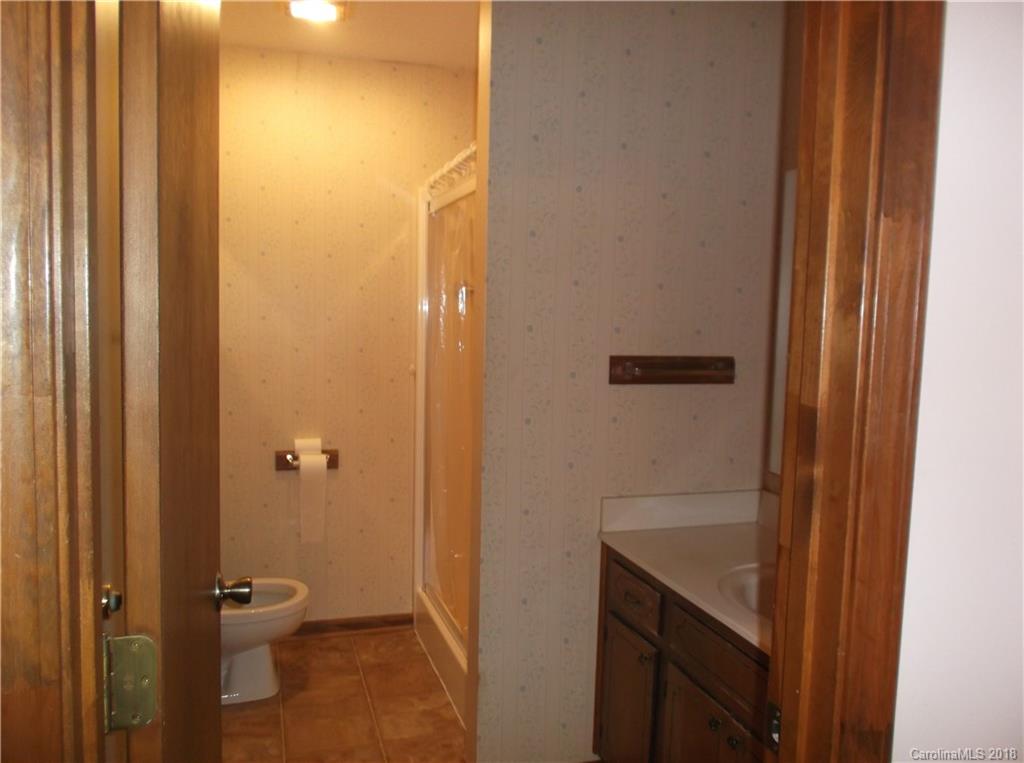 1835 Rainey Road Salisbury, NC 28146 - Photo 17 of 17 a bathroom with a granite countertop sink a toilet and shower