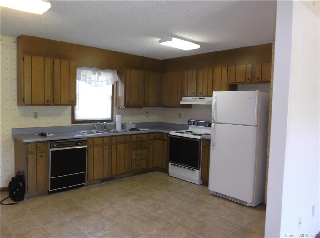 1835 Rainey Road Salisbury, NC 28146 - Photo 6 of 17 a kitchen with granite countertop a refrigerator stove a sink and dishwasher with wooden floor