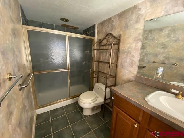 24502 Rd North Cortez, CO 81321 - Photo 13 of 35 a bathroom with a granite countertop sink toilet and shower