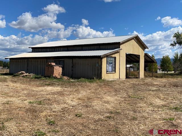 24502 Rd North Cortez, CO 81321 - Photo 20 of 35 a front view of a house with a yard and garage