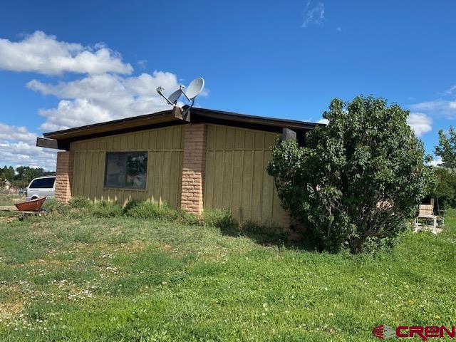 24502 Rd North Cortez, CO 81321 - Photo 6 of 35 a backyard of a house with plants and tree