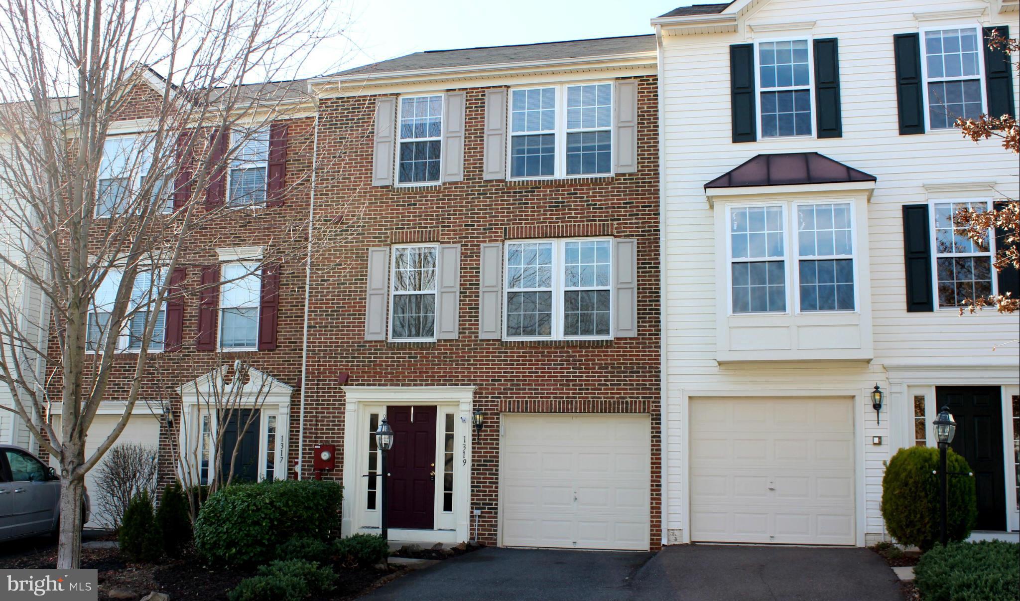 a front view of a residential apartment building with a yard