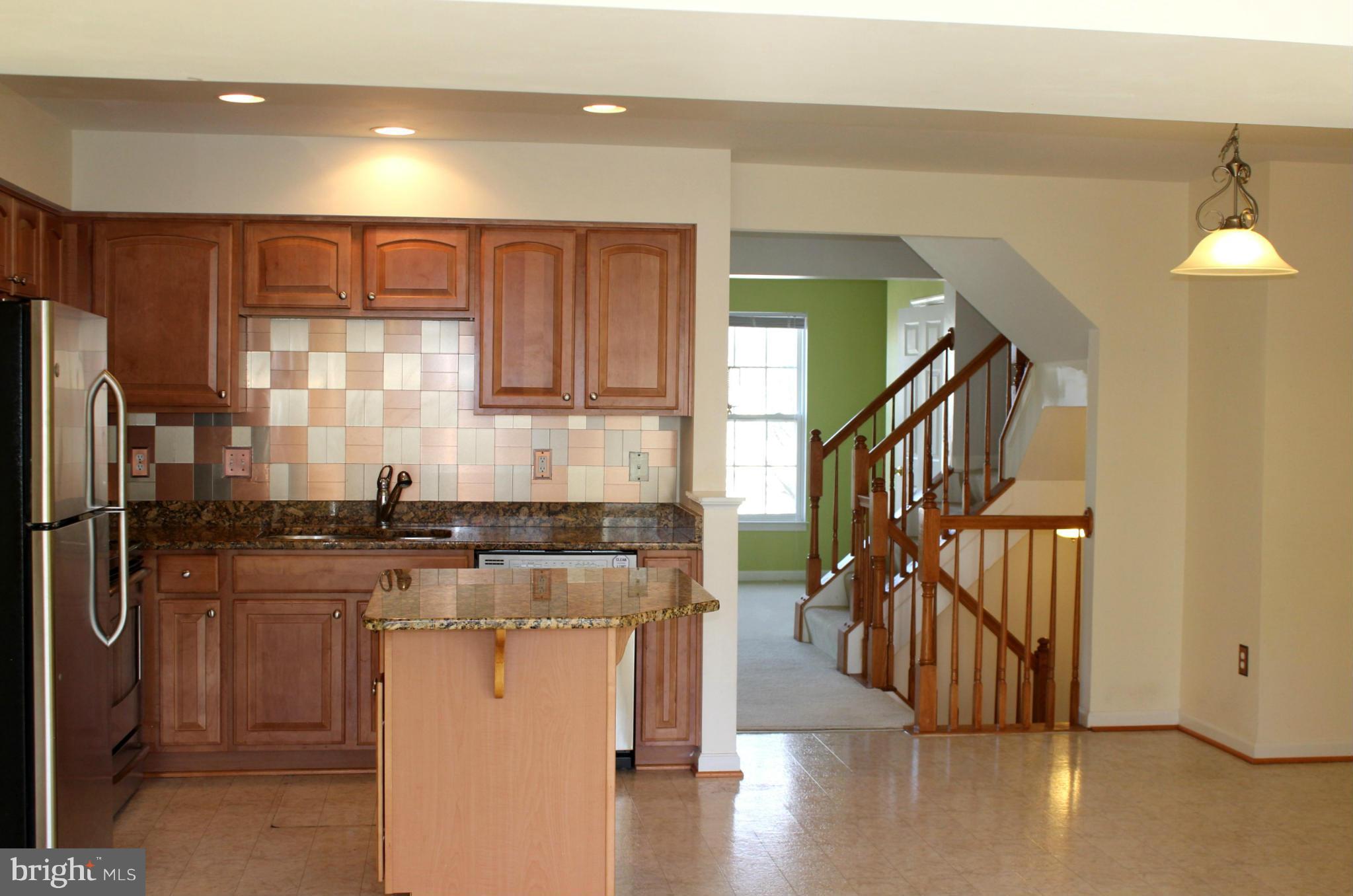 1319 Steed Street Ranson, WV 25438 - Photo 12 of 22 a kitchen with stainless steel appliances granite countertop a refrigerator a stove and a wooden floors